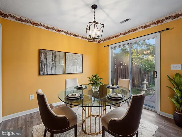 a dining room with furniture a window and a chandelier