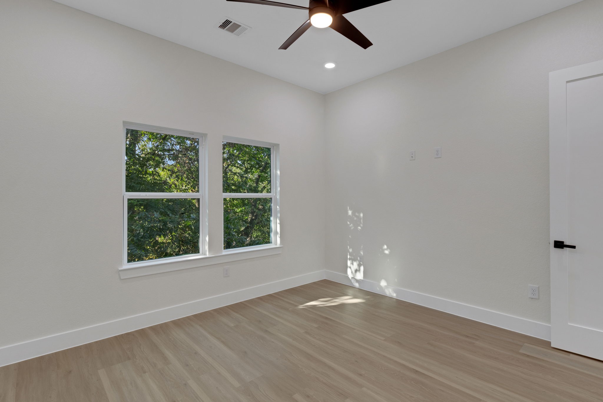 7962 Ethel Street, Unit A Houston, TX 77028 - Photo 17 of 25 wooden floor in an empty room with a window