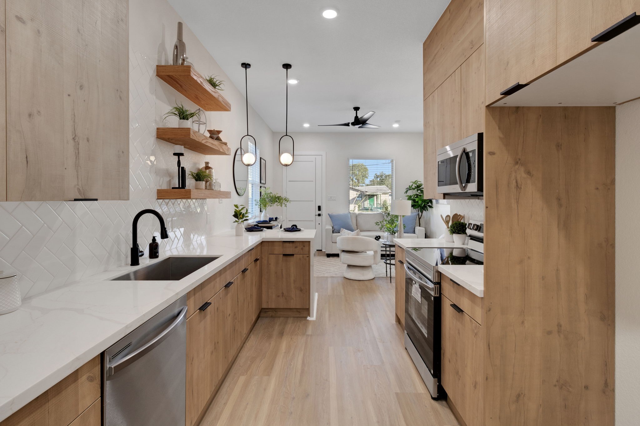 7962 Ethel Street, Unit A Houston, TX 77028 - Photo 4 of 25 a kitchen with stainless steel appliances a sink stove and refrigerator