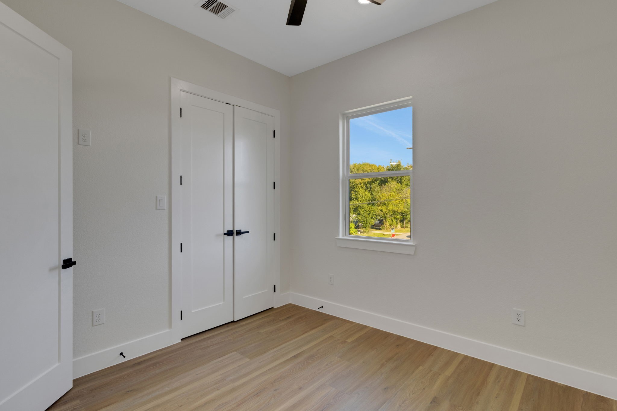 7962 Ethel Street, Unit A Houston, TX 77028 - Photo 10 of 25 a view of an empty room with wooden floor and windows