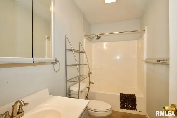 a bathroom with a toilet and shower