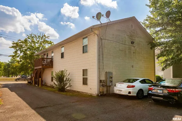 a couple of cars parked in front of a house
