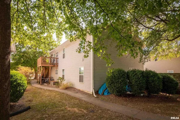 a view of a backyard with sitting area and garden