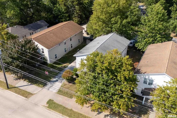 an aerial view of a house with garden space and street view