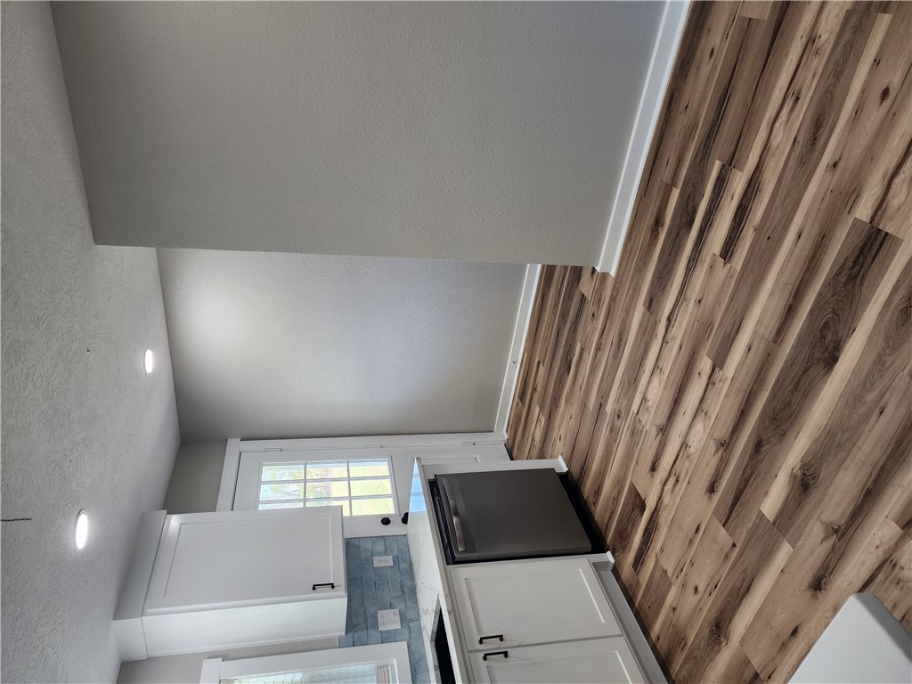 12877 East State Highway 21 Bryan, TX 77808 - Photo 15 of 48 a room with a sink cabinets and wooden floor