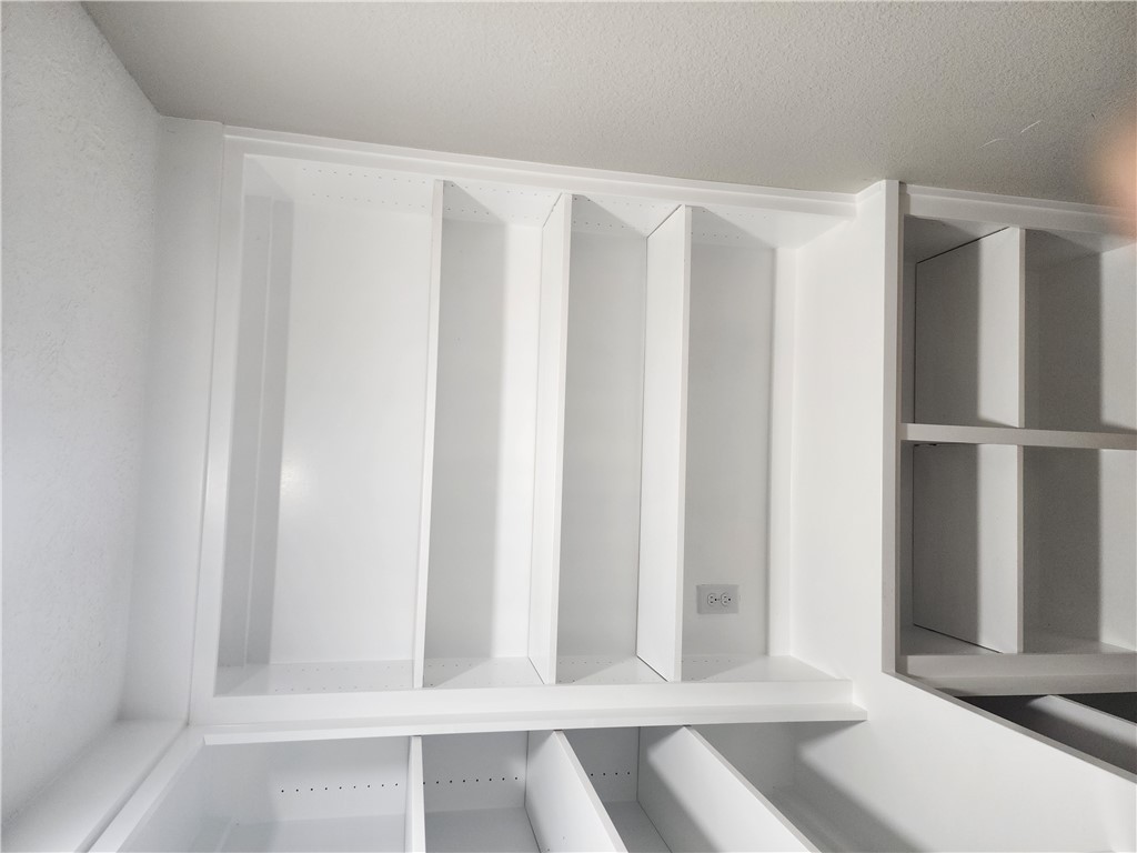 12877 East State Highway 21 Bryan, TX 77808 - Photo 18 of 48 a view of walk in closet with empty racks