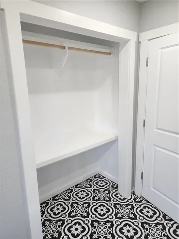a bathroom with a black white checkered floor and a window