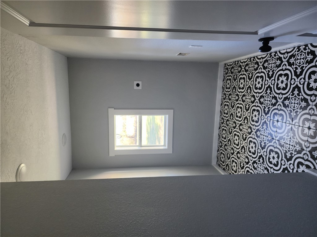 12877 East State Highway 21 Bryan, TX 77808 - Photo 24 of 48 a bathroom with a black white checkered floor and a window