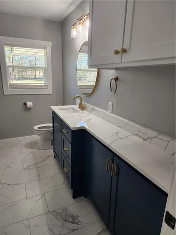 a bathroom with a sink a vanity and a mirror