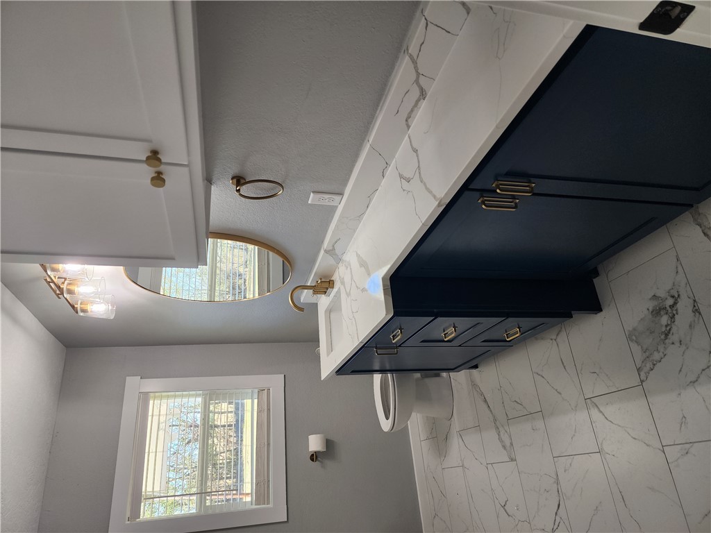 12877 East State Highway 21 Bryan, TX 77808 - Photo 25 of 48 a bathroom with a double vanity sink a toilet and a mirror