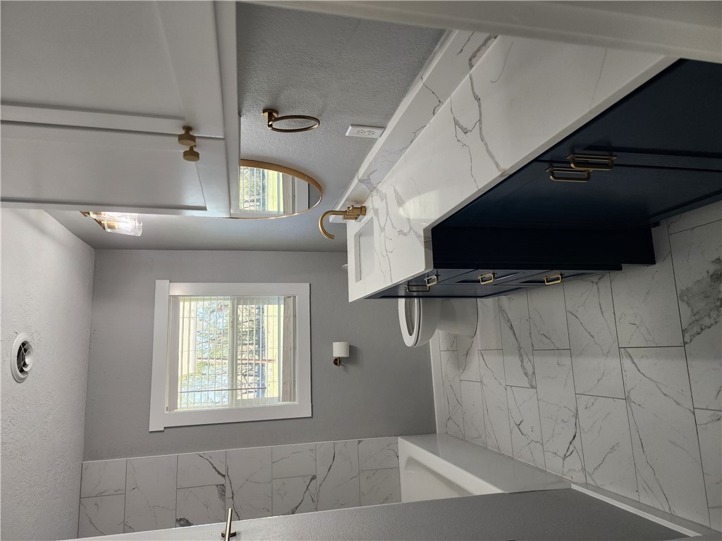 12877 East State Highway 21 Bryan, TX 77808 - Photo 26 of 48 a bathroom with a sink a vanity and a mirror