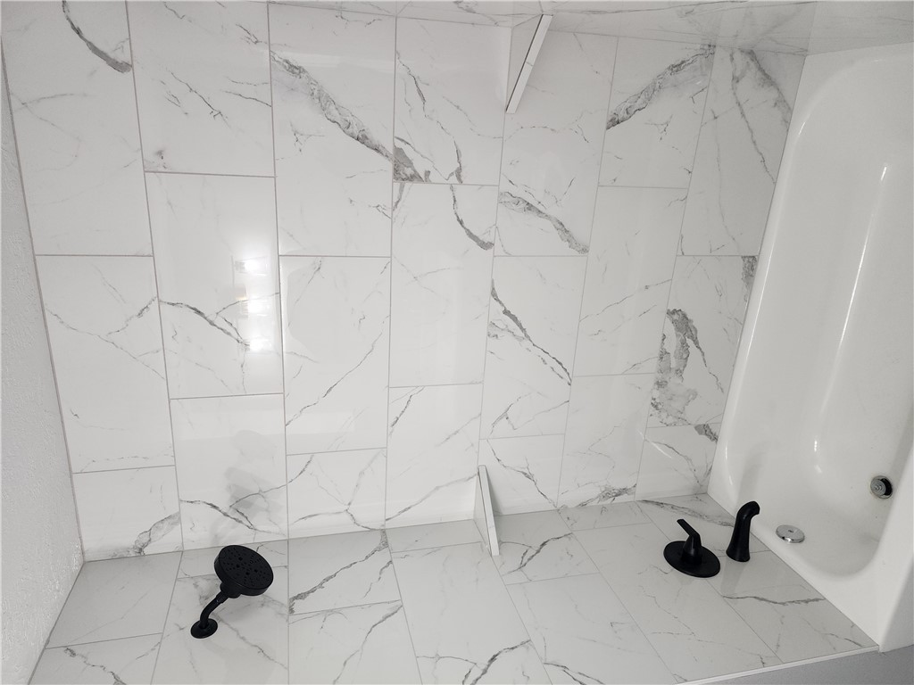 12877 East State Highway 21 Bryan, TX 77808 - Photo 27 of 48 a bathroom with a bathtub