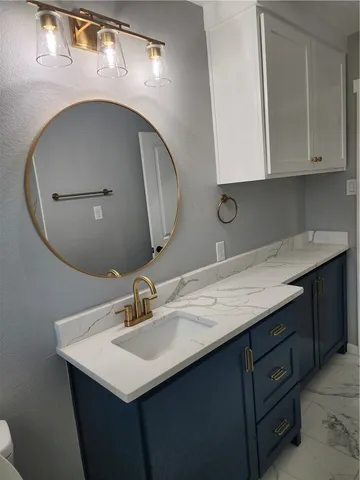 a view of a hallway with wooden floor and white walls