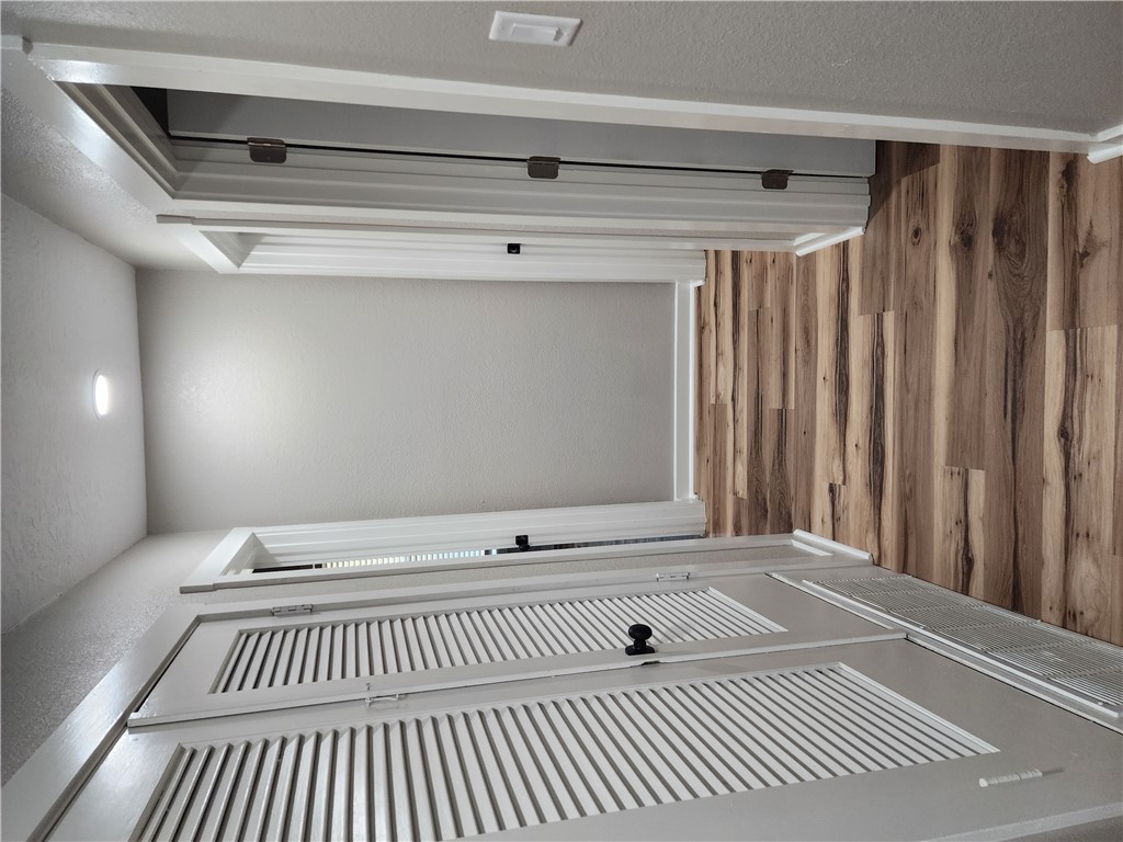 12877 East State Highway 21 Bryan, TX 77808 - Photo 29 of 48 a view of a hallway with wooden floor and white walls