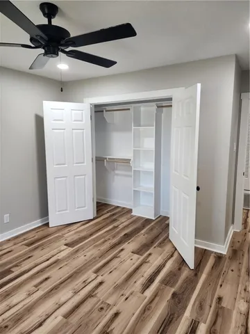 a view of a bedroom with wooden floor and bedroom