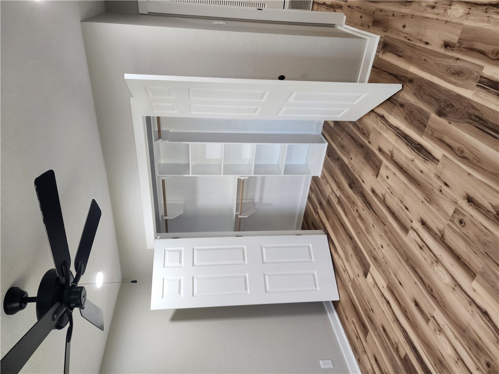 12877 East State Highway 21 Bryan, TX 77808 - Photo 31 of 48 a bedroom with a bed and a chandelier fan