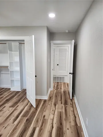 a view of a room with wooden floor and fan