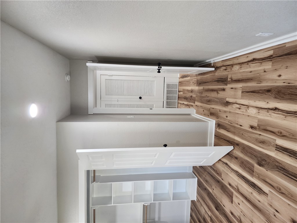 12877 East State Highway 21 Bryan, TX 77808 - Photo 32 of 48 a view of a bedroom with wooden floor and bedroom