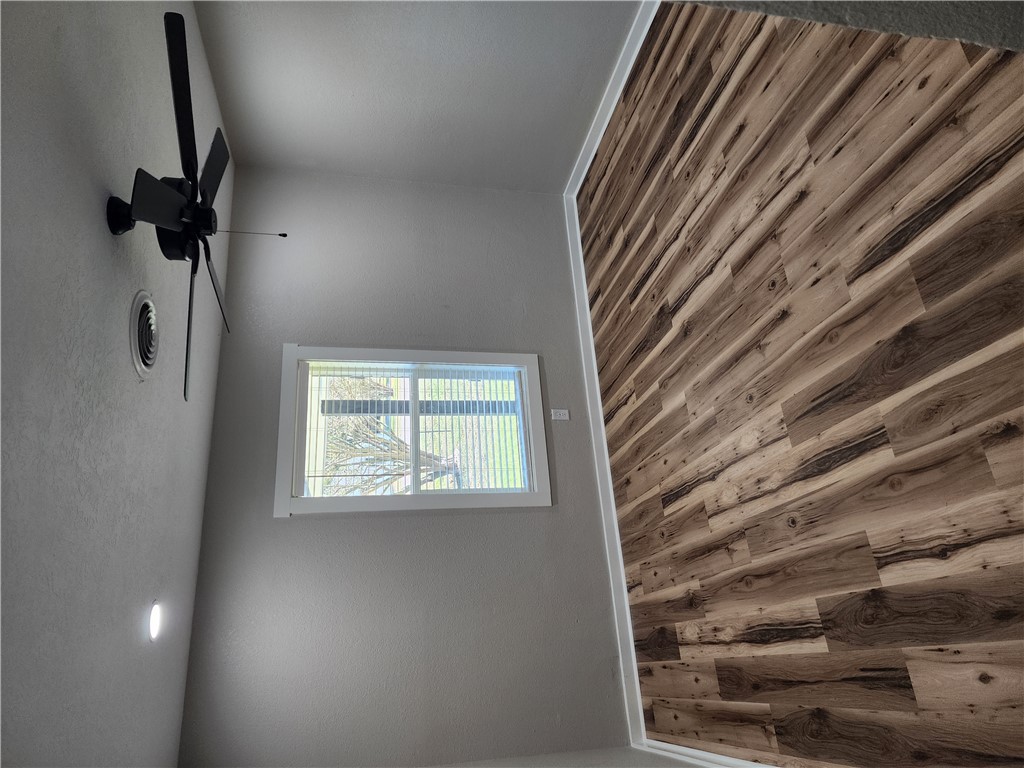 12877 East State Highway 21 Bryan, TX 77808 - Photo 33 of 48 a view of a room with wooden floor and fan