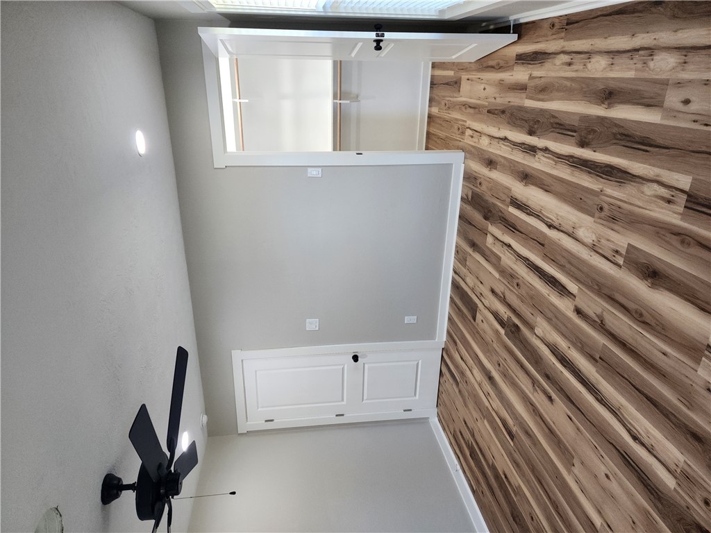 12877 East State Highway 21 Bryan, TX 77808 - Photo 36 of 48 a view of a room with a bed and wooden floor