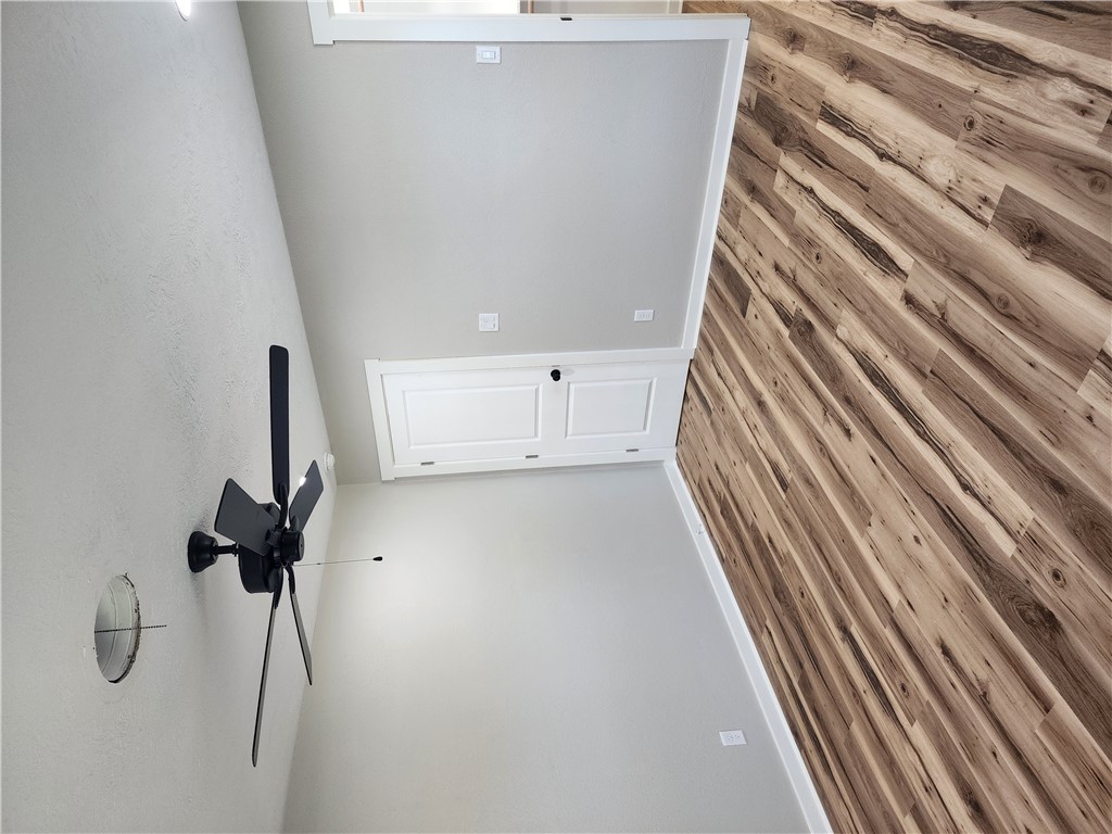 12877 East State Highway 21 Bryan, TX 77808 - Photo 37 of 48 a view of a room with a ceiling fan and wooden floor