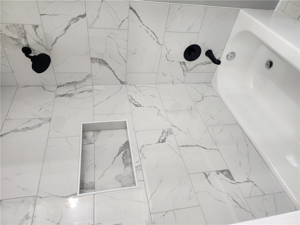 12877 East State Highway 21 Bryan, TX 77808 - Photo 40 of 48 a bathroom with a bathtub