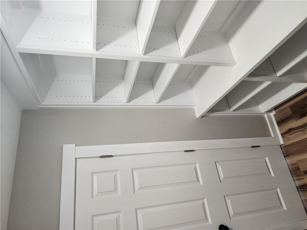 12877 East State Highway 21 Bryan, TX 77808 - Photo 42 of 48 a view of walk in closet with empty racks