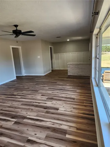 a view of a room with wooden floor