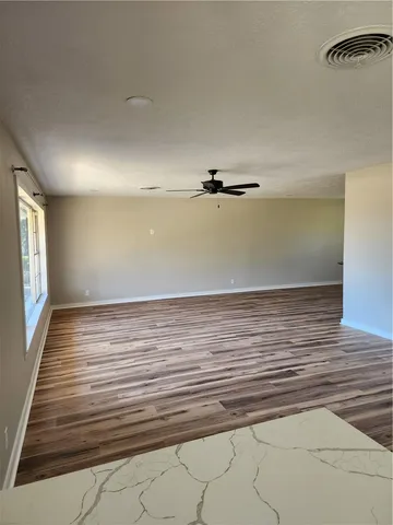 en empty room with wooden floor