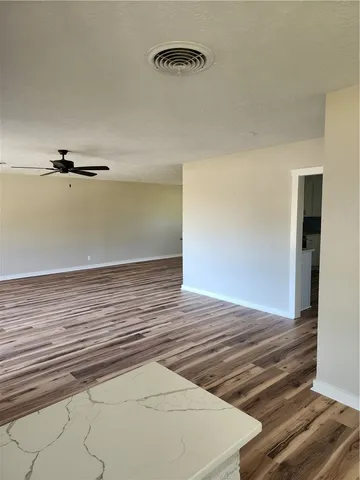 a view of a room with wooden floor
