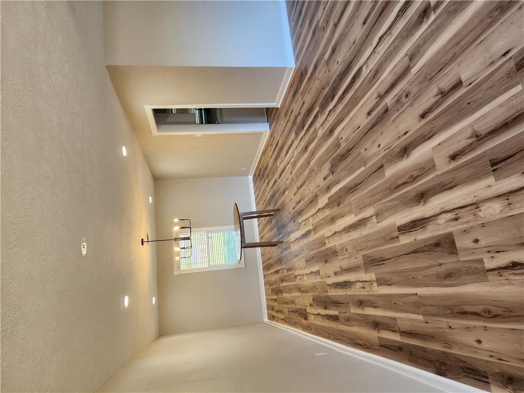 12877 East State Highway 21 Bryan, TX 77808 - Photo 9 of 48 a view of an empty room with window and wooden floor