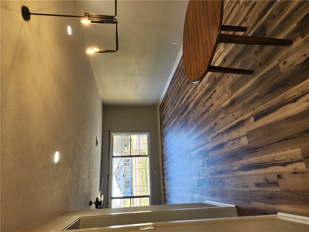 12877 East State Highway 21 Bryan, TX 77808 - Photo 10 of 48 an empty room with wooden floor and windows