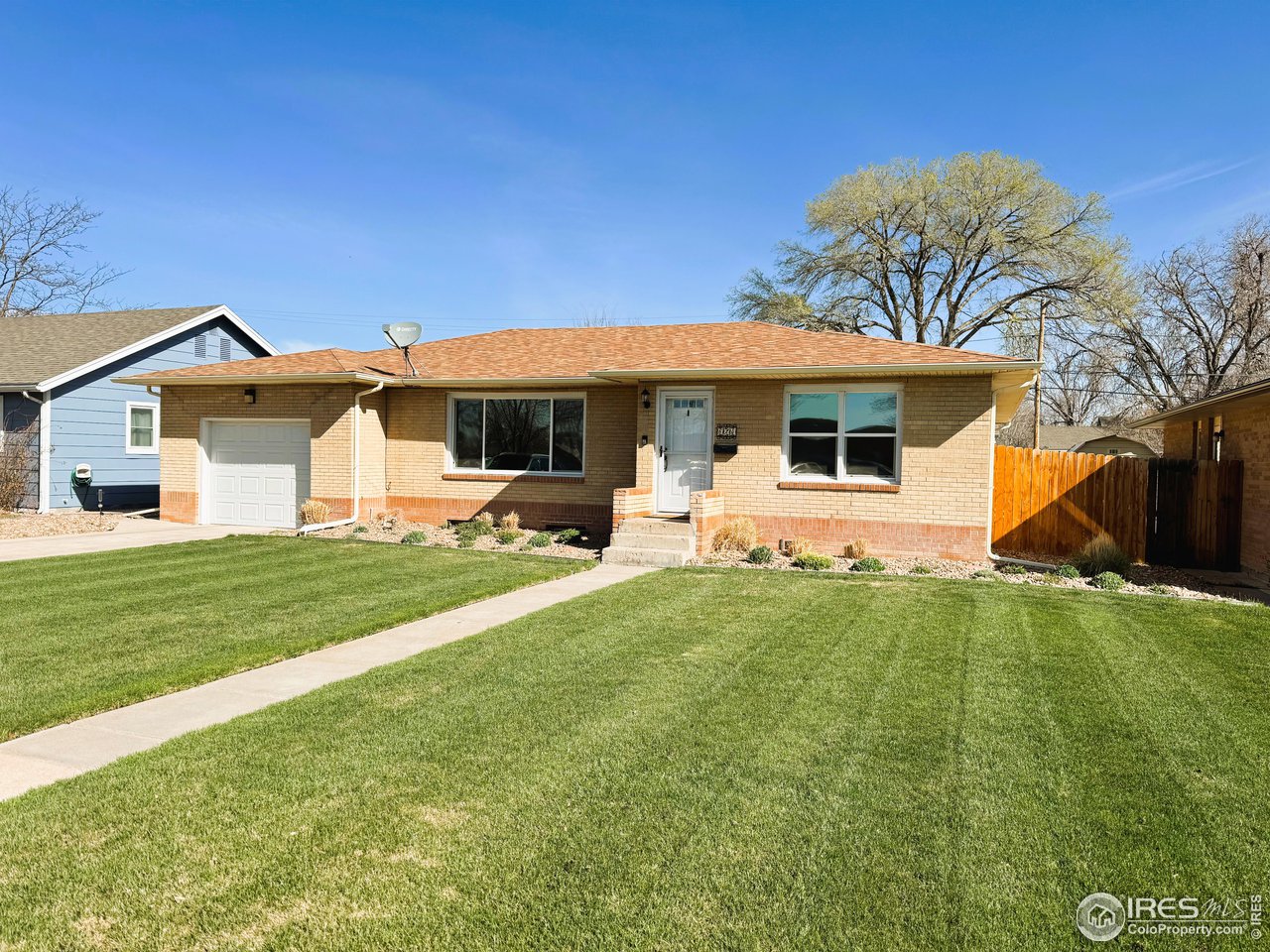 624 Fairhurst Street Sterling, CO 80751 - Photo 1 of 27 a front view of a house with garden