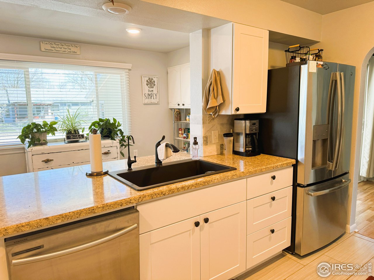 624 Fairhurst Street Sterling, CO 80751 - Photo 11 of 27 a kitchen with appliances a sink and cabinets