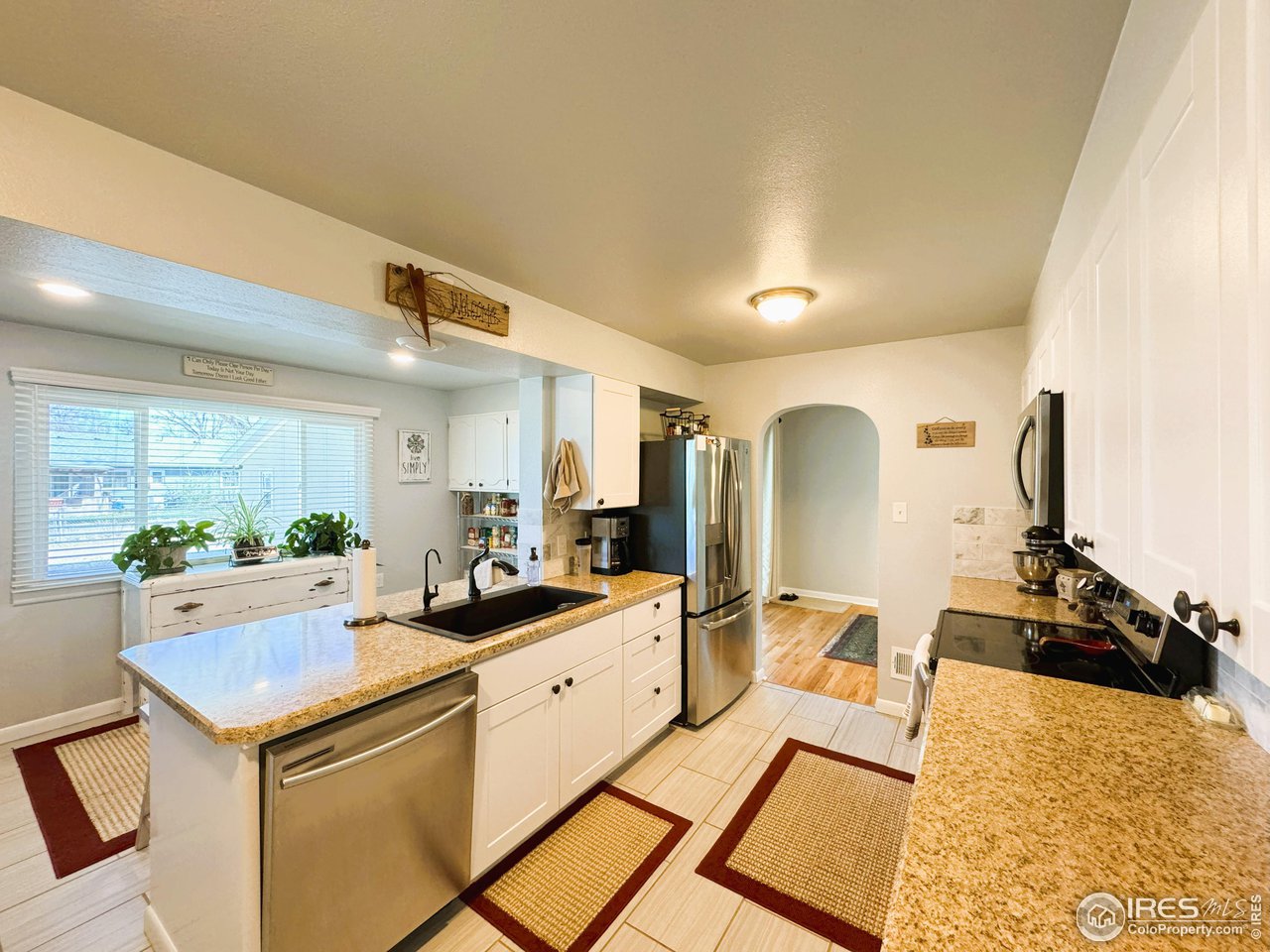 624 Fairhurst Street Sterling, CO 80751 - Photo 12 of 27 a kitchen with a sink appliances and cabinets