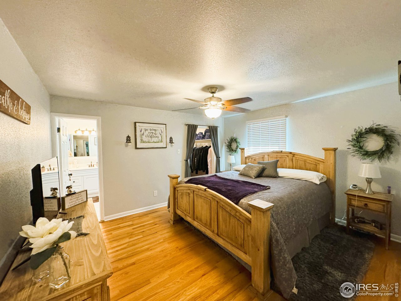 624 Fairhurst Street Sterling, CO 80751 - Photo 13 of 27 a bedroom with a bed and wooden floor