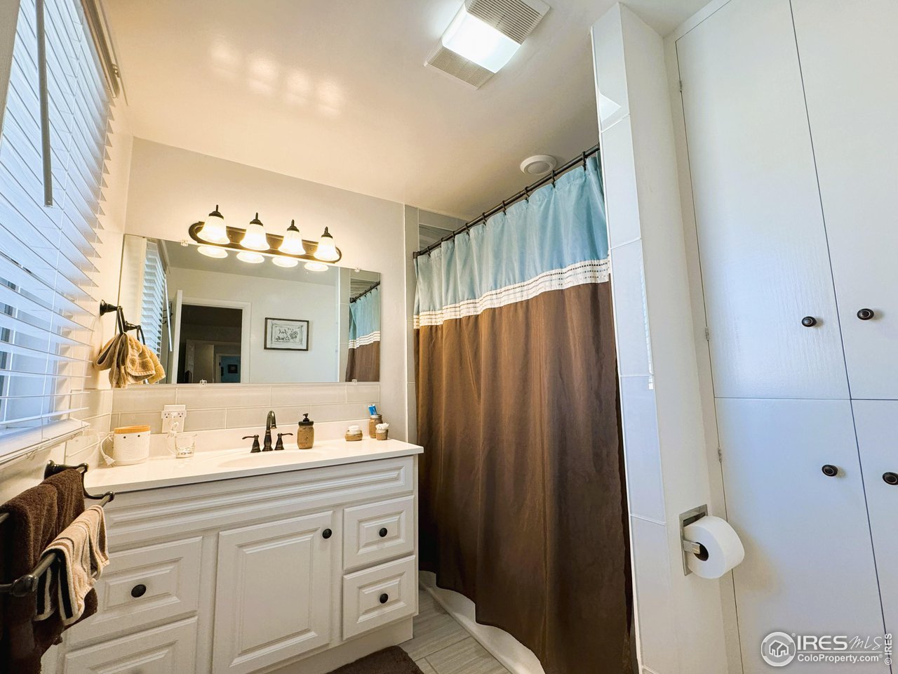 624 Fairhurst Street Sterling, CO 80751 - Photo 15 of 27 a bathroom with a sink vanity and a mirror
