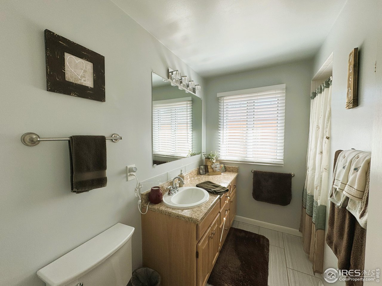 624 Fairhurst Street Sterling, CO 80751 - Photo 19 of 27 a bathroom with a sink a toilet and a bathtub