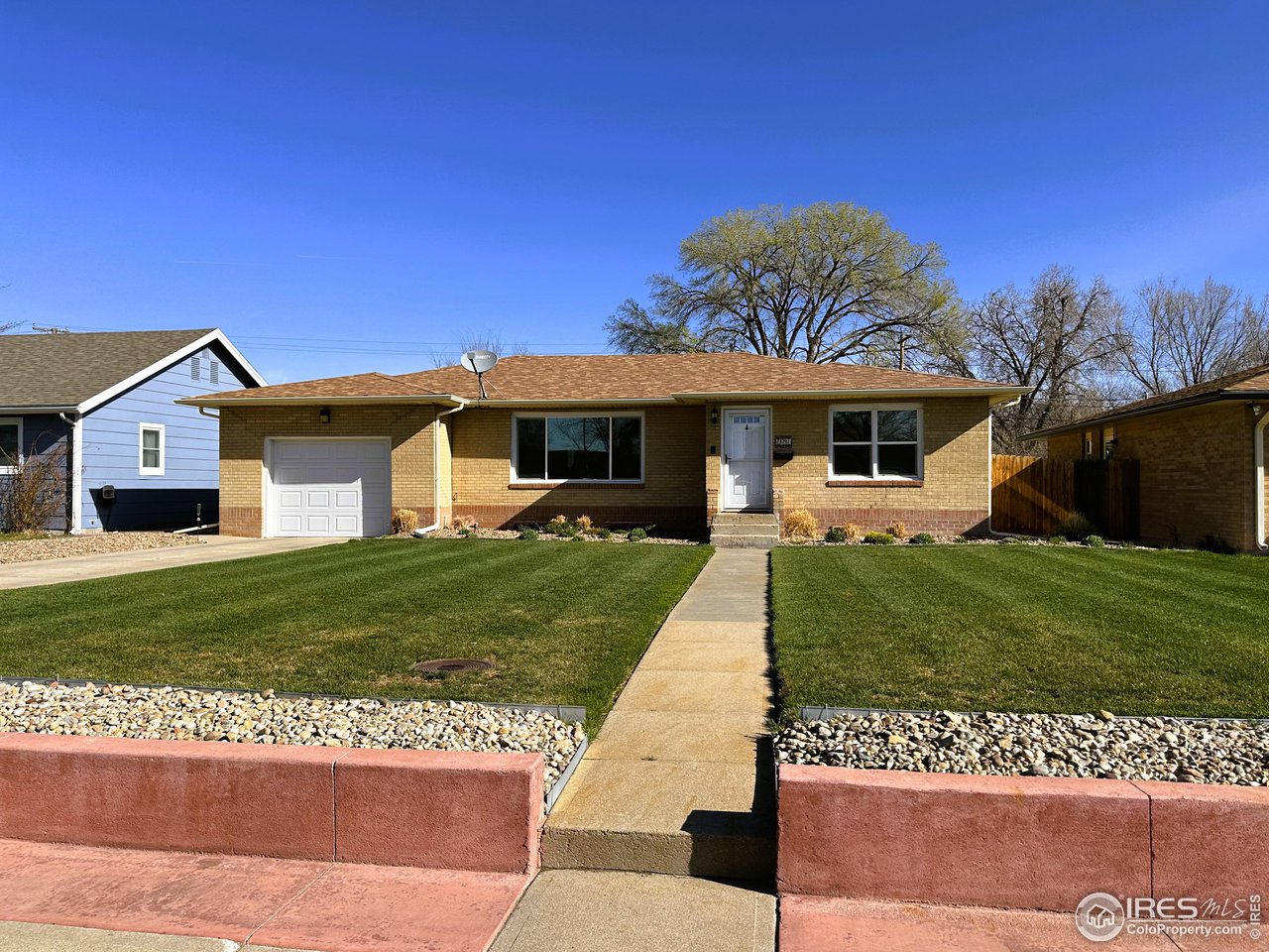 624 Fairhurst Street Sterling, CO 80751 - Photo 2 of 27 a front view of a house with a garden