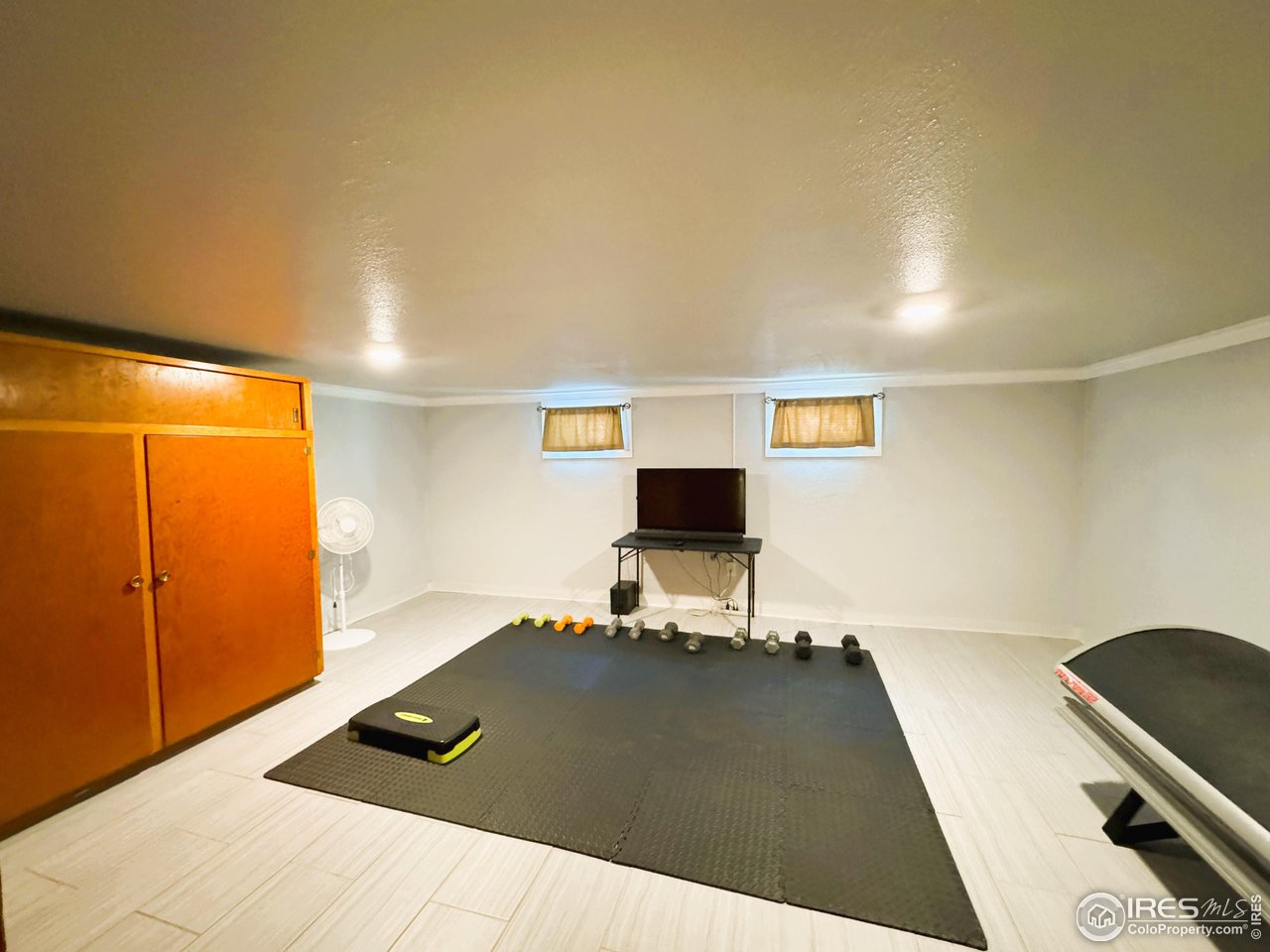 624 Fairhurst Street Sterling, CO 80751 - Photo 21 of 27 a living room with a bed furniture and a flat screen tv