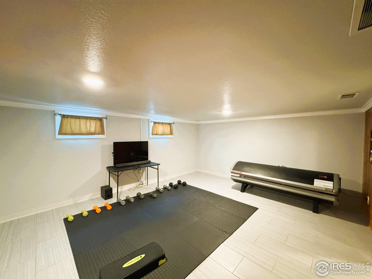 624 Fairhurst Street Sterling, CO 80751 - Photo 22 of 27 a living room with furniture and a flat screen tv