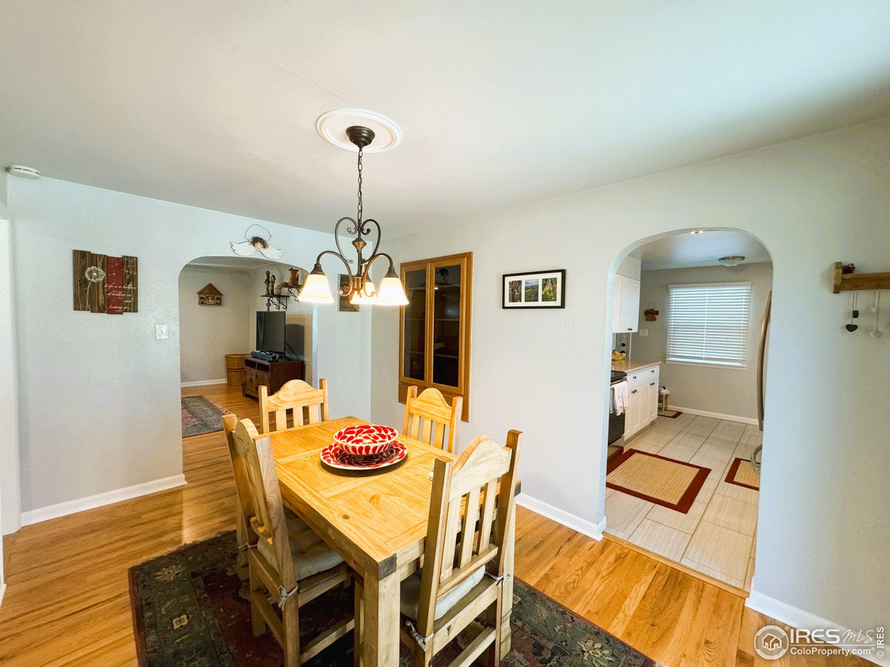 624 Fairhurst Street Sterling, CO 80751 - Photo 6 of 27 a dining room with furniture and wooden floor