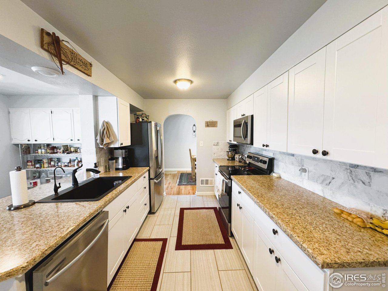 624 Fairhurst Street Sterling, CO 80751 - Photo 8 of 27 a large kitchen with granite countertop lots of counter top space
