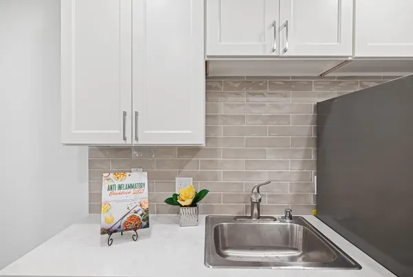 a kitchen with a sink and cabinets