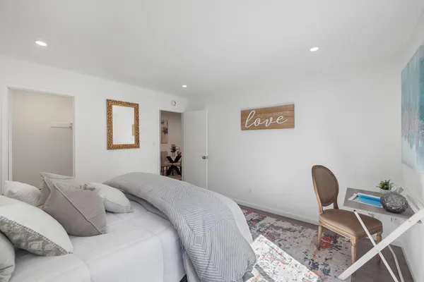 a bedroom with a bed and a chair