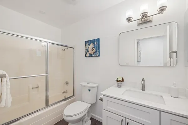 a bathroom with a sink a toilet and shower