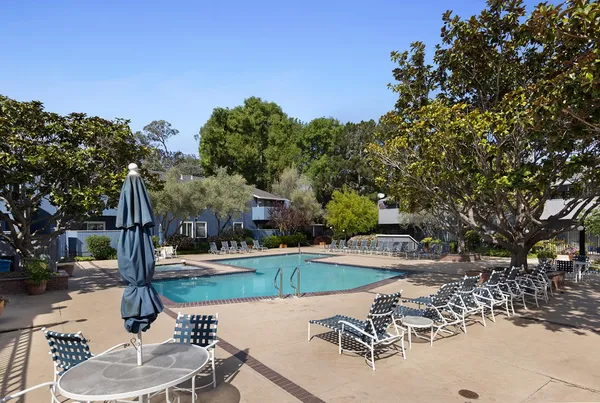 a swimming pool with outdoor seating and yard
