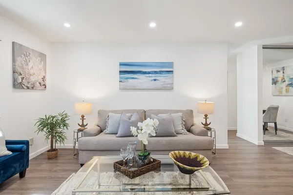 a living room with furniture and wooden floor
