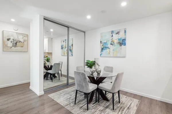 a dining room with furniture and wooden floor