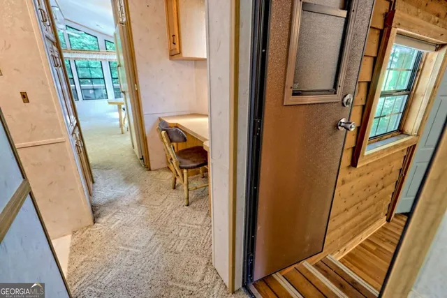 a view of a balcony with wooden floor and furniture
